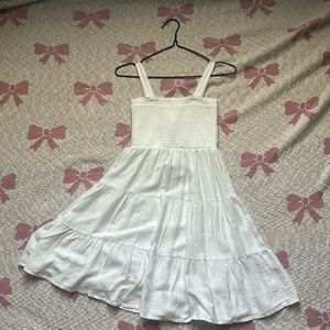 Super cute white dress. With the cutest flower detailing.